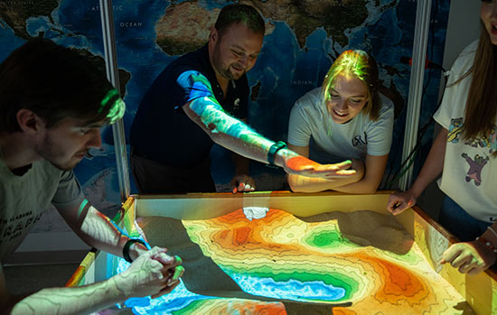 Students at sand table