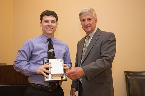 Patrick Bigbie accepts the Outstanding Contribution Award from Dr. Bill Williams.