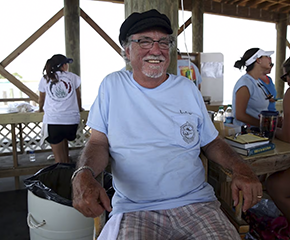 Dr. Bob Shipp sitting in chair outside smiling.