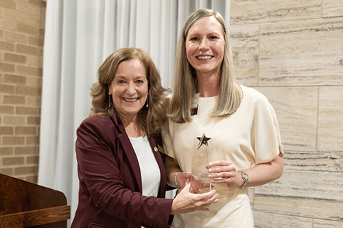 Dr. Bonnie R. Rush, dean of Texas A&M College of Veterinary Medicine & Biomedical Sciences, presents Dr. Meghan Hermance, associate professor of microbiology and immunology at the Whiddon College of Medicine, with the Rising Star Award at a reception in June.