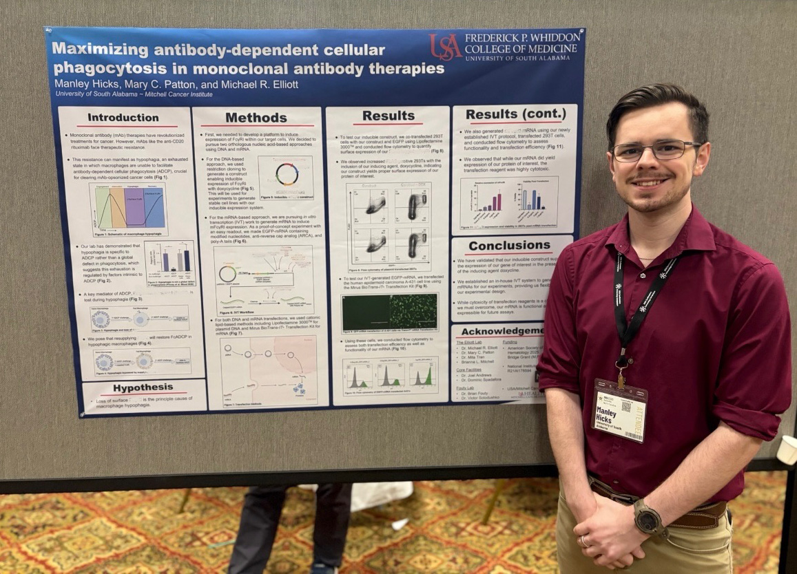 Graduate student with research poster