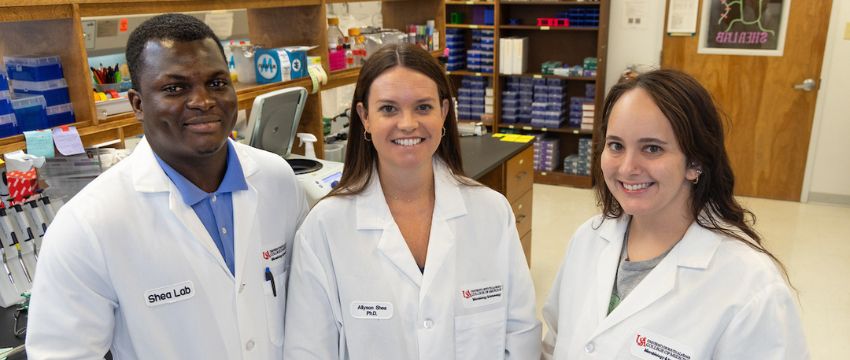 COM faculty posing in lab.