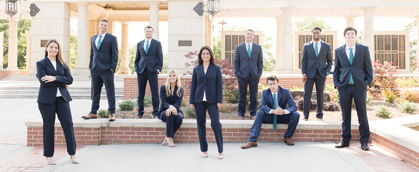 MCOB Scholars standing at Moulton Tower.