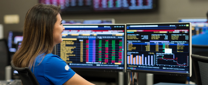 Student analyzing metrics in MCOB from dual monitors