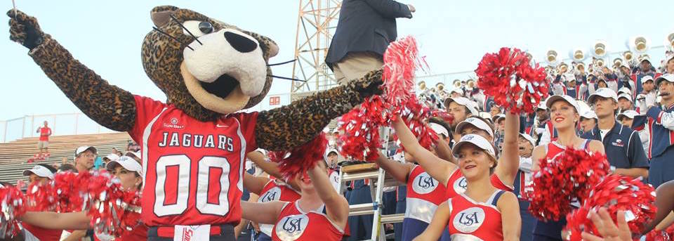 Southpaw in front of band at game.