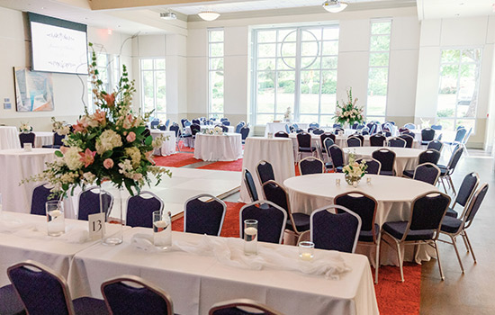 The inside of the Chief Calvin McGhee grand ballroom with tables and chairs set up for event.