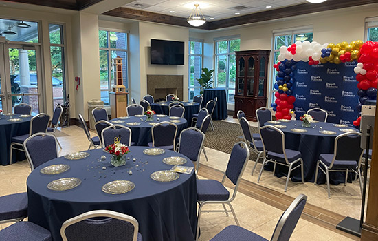 USA Foundation Grand Lobby with table and chairs and balloon backdrop.
