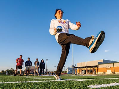 NATHAN SANSOM tries out for drum major at the new Geri and Gordon Moulton Jaguar Marching Band Complex. He and Hailey Romoser, third from left behind Sansom, were selected to join returning drum major Rivers Lewis to lead the band for the 2026-27 academic year. 
