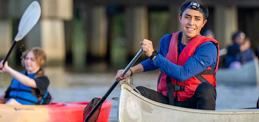 Male student in kayak in water